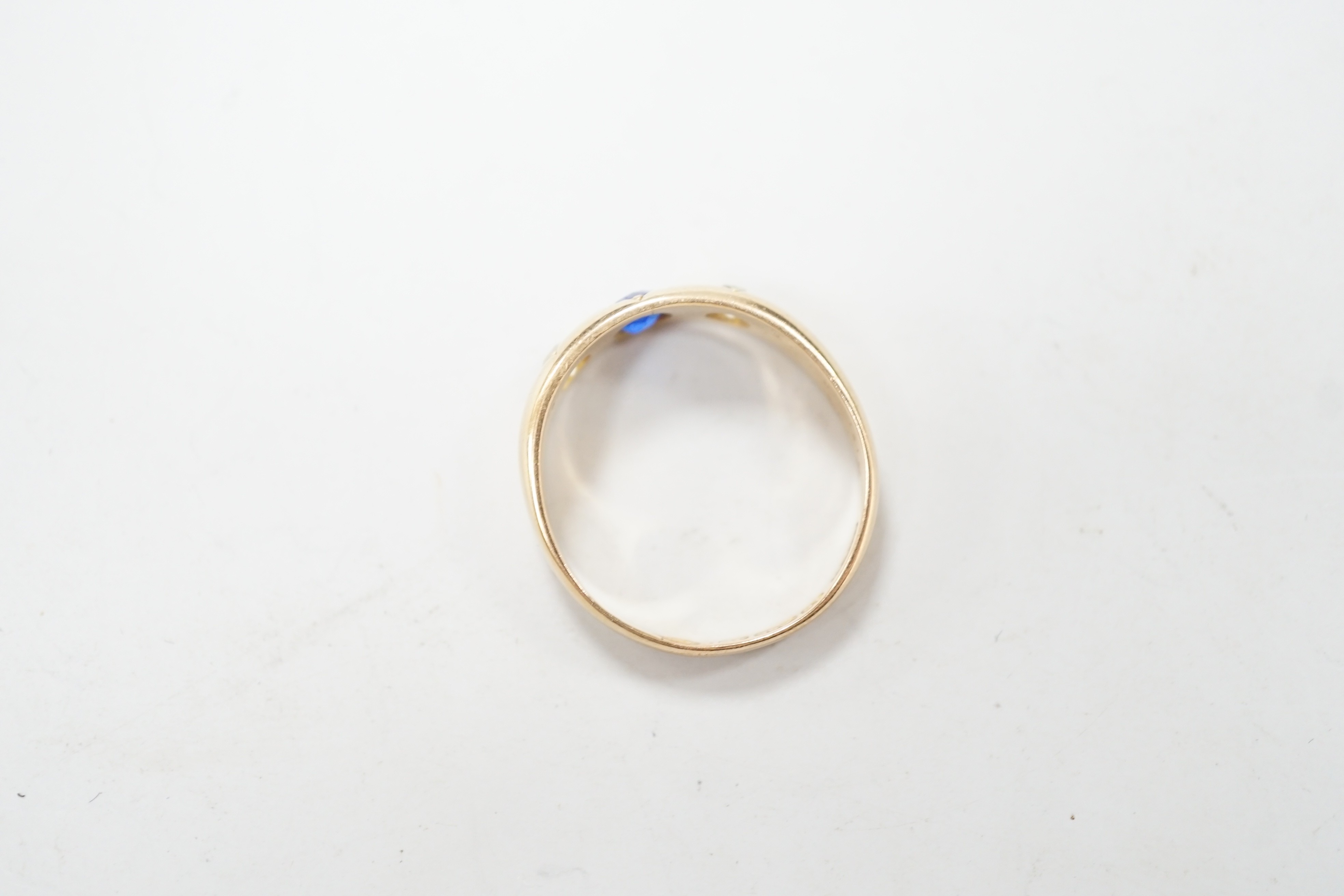 A late Victorian 15ct gold and gypsy set three stone gem set ring, size Q/R, gross weight 4.3 grams.